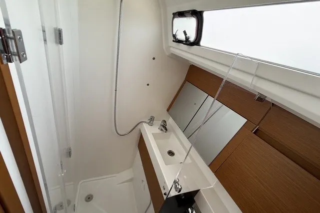 Slide: The Image of Modern bathroom in 2022 Jeanneau Sun Odyssey 410 yacht with sleek fixtures and mirror. - 19