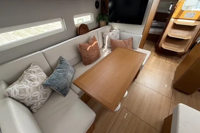 Slide: The Image of Interior of 2022 Jeanneau Sun Odyssey 410 yacht with cozy seating and wooden table. - 35
