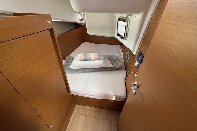 Slide: The Image of Cozy cabin interior of 2022 Jeanneau Sun Odyssey 410 sailboat with wooden finish. - 49