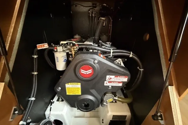 Slide: The Image of Engine compartment of a 2022 Jeanneau Sun Odyssey 410 sailboat, showcasing mechanical components. - 57
