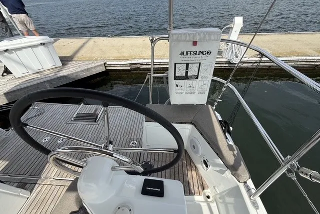Slide: The Image of Cockpit of 2022 Jeanneau Sun Odyssey 410 sailboat with steering wheel and safety equipment. - 17