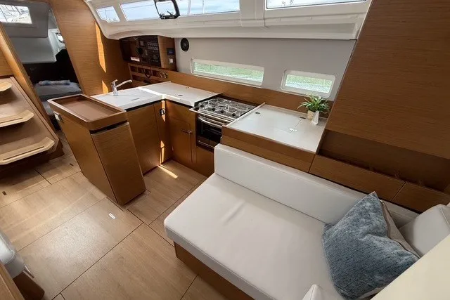 Slide: The Image of Modern interior of 2022 Jeanneau Sun Odyssey 410 yacht with kitchen and seating area. - 38