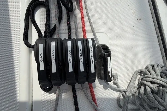 Slide: The Image of Rope clutches on Jeanneau Sun Odyssey 410 sailboat, labeled for various sailing functions. - 22