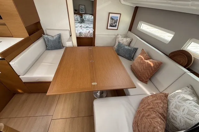 Slide: The Image of Interior of 2022 Jeanneau Sun Odyssey 410 yacht with cozy seating and wooden table. - 33