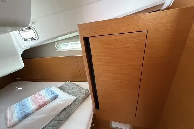 Slide: The Image of Cozy cabin interior of 2022 Jeanneau Sun Odyssey 410 sailboat with wooden finish. - 51