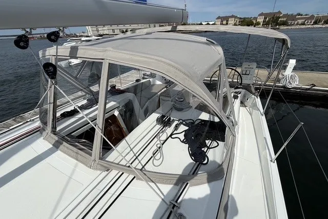 Slide: The Image of 2022 Jeanneau Sun Odyssey 410 sailboat with canopy docked at marina. - 24