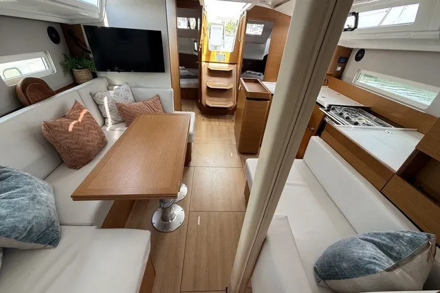 Slide: The Image of Interior of 2022 Jeanneau Sun Odyssey 410 yacht with modern seating and dining area. - 37