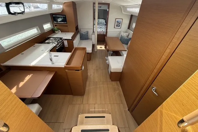 Slide: The Image of Modern interior of 2022 Jeanneau Sun Odyssey 410 yacht with kitchen and seating area. - 31
