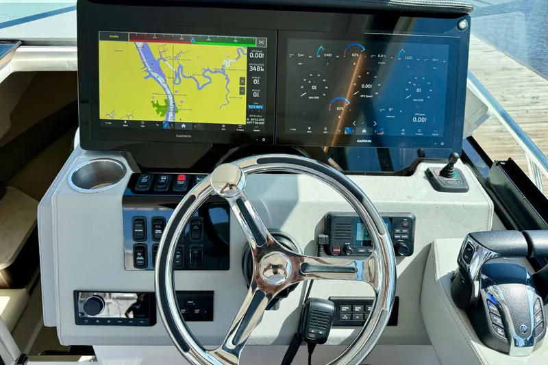 Slide: The Image of 2023 Regal 36 XO helm with dual Garmin displays and modern controls. - 25