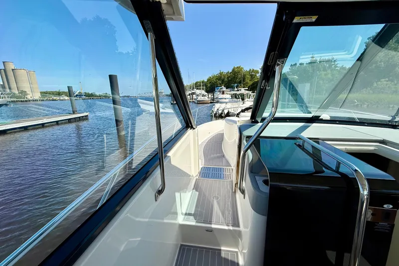 Slide: The Image of 2023 Regal 36 XO yacht interior with waterfront view, showcasing sleek design and modern amenities. - 27