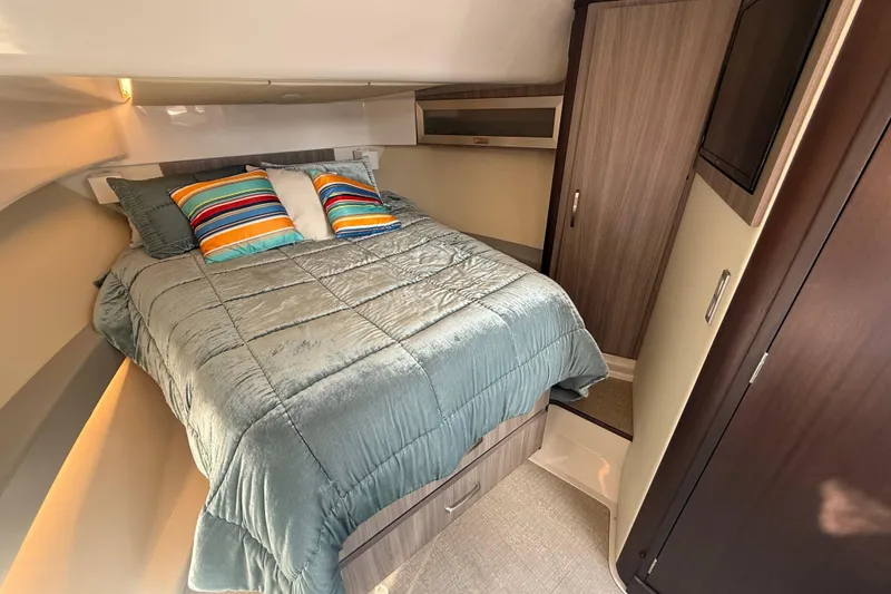 Slide: The Image of Cozy cabin interior of 2023 Regal 36 XO yacht with colorful bedding and wood accents. - 32