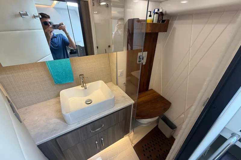 Slide: The Image of Modern bathroom interior on 2023 Regal 36 XO yacht, featuring sleek sink and shower. - 40