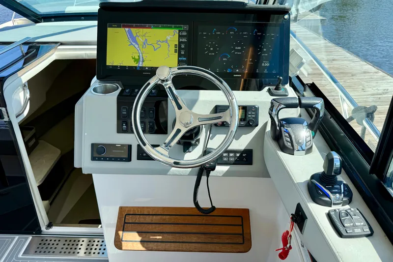 Slide: The Image of Helm of 2023 Regal 36 XO boat with navigation screens and controls. - 23