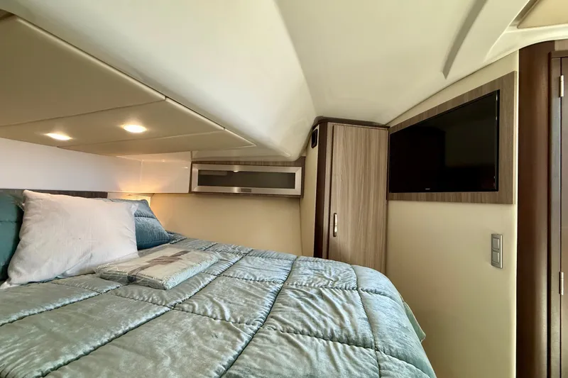 Slide: The Image of Luxurious cabin interior of 2023 Regal 36 XO yacht with cozy bedding and modern amenities. - 33