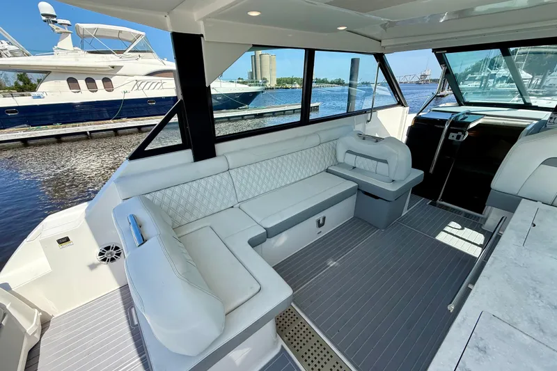 Slide: The Image of 2023 Regal 36 XO yacht interior with luxurious seating and modern design. - 16