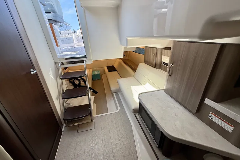 Slide: The Image of 2023 Regal 36 XO yacht interior with modern seating and cabinetry. - 34