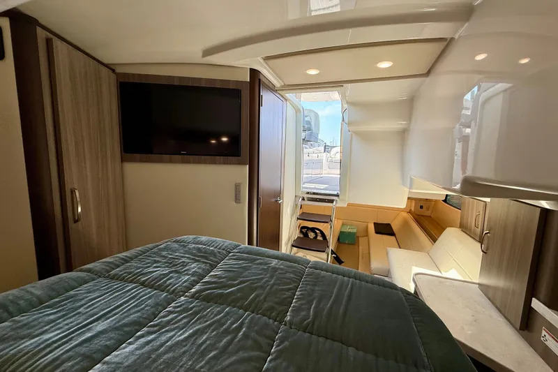 Slide: The Image of Luxurious interior of 2023 Regal 36 XO yacht with cozy bed and modern amenities. - 36