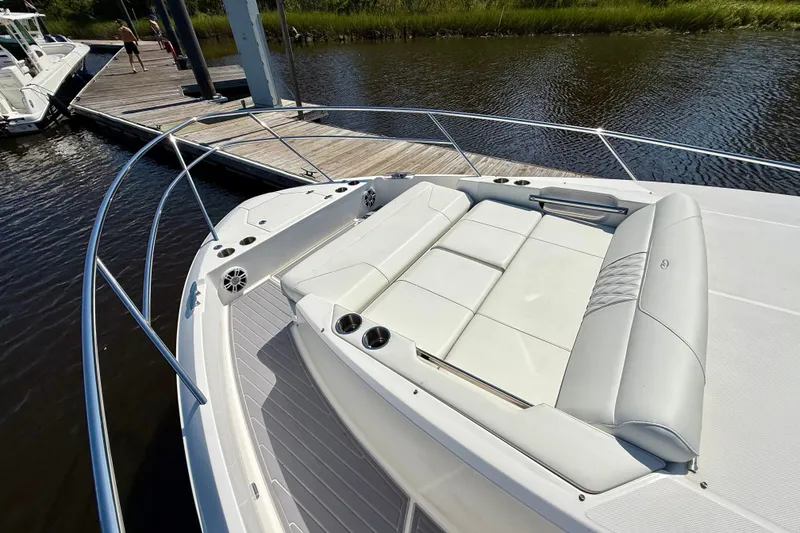 Slide: The Image of Luxurious seating on 2023 Regal 36 XO boat docked by the water. - 28