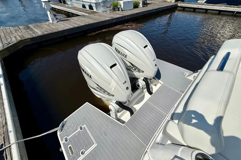 Slide: The Image of 2023 Regal 36 XO boat with twin Yamaha V8 engines docked at marina. - 13