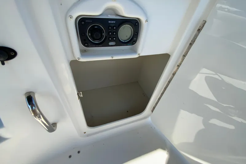 Slide: The Image of 2010 Hurricane SunDeck Sport 200 OB boat storage compartment with Sony stereo system. - 19