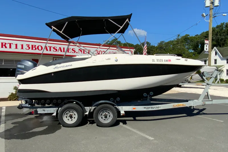 The Image of 2010 Hurricane SunDeck Sport 200 OB boat on trailer at dealership. - 1