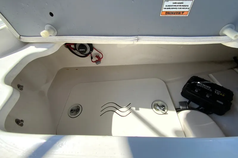 Slide: The Image of Open storage compartment in 2010 Hurricane SunDeck Sport 200 OB boat. - 23
