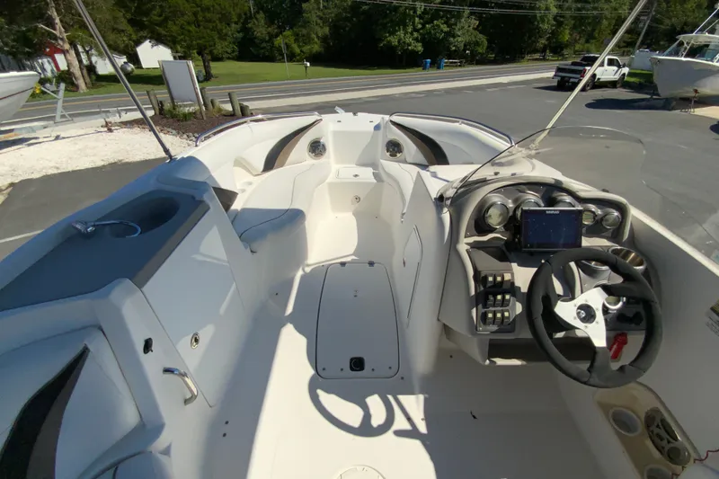 Slide: The Image of 2010 Hurricane SunDeck Sport 200 OB boat interior with steering console and seating area. - 14