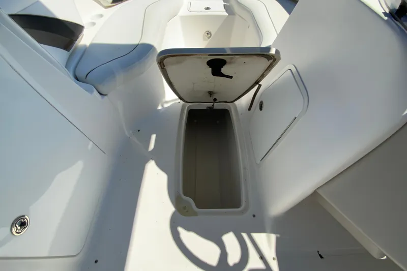 Slide: The Image of Open storage compartment on 2010 Hurricane SunDeck Sport 200 OB boat interior. - 21