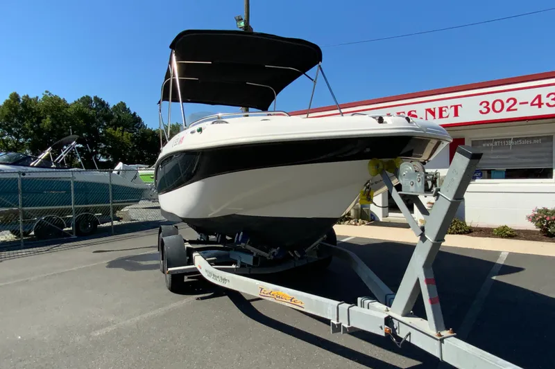 Slide: The Image of 2010 Hurricane SunDeck Sport 200 OB boat on trailer, parked outside dealership. - 3