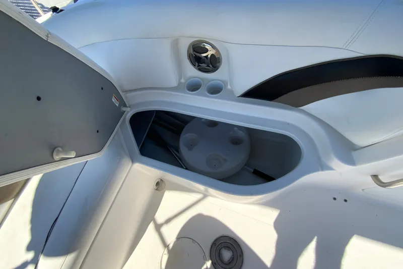 Slide: The Image of Interior view of a 2010 Hurricane SunDeck Sport 200 OB boat, featuring storage compartment. - 22