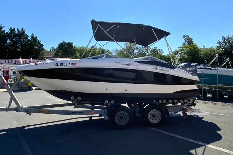 Slide: The Image of 2010 Hurricane SunDeck Sport 200 OB boat on trailer, parked outdoors. - 6