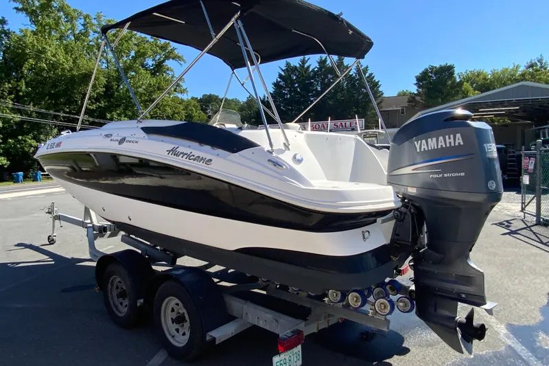 Slide: The Image of 2010 Hurricane SunDeck Sport 200 OB boat with Yamaha outboard motor on trailer. - 7