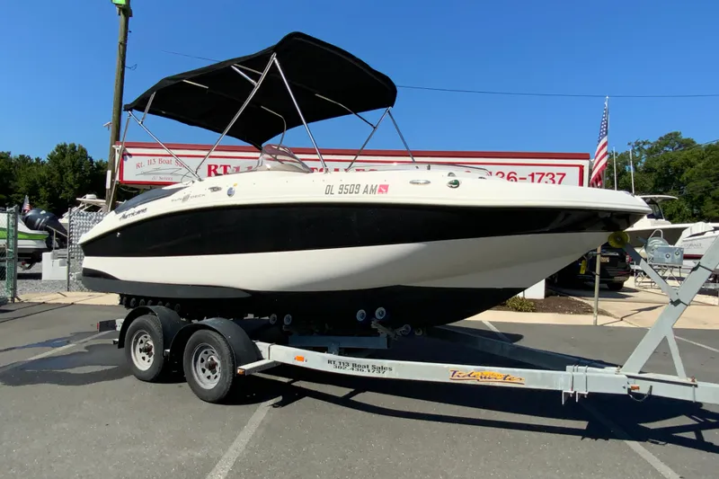 Slide: The Image of 2010 Hurricane SunDeck Sport 200 OB boat on trailer at dealership. - 2