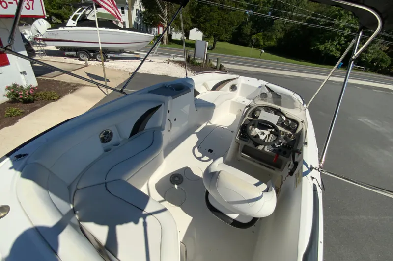 Slide: The Image of 2010 Hurricane SunDeck Sport 200 OB boat interior with seating and steering console. - 10