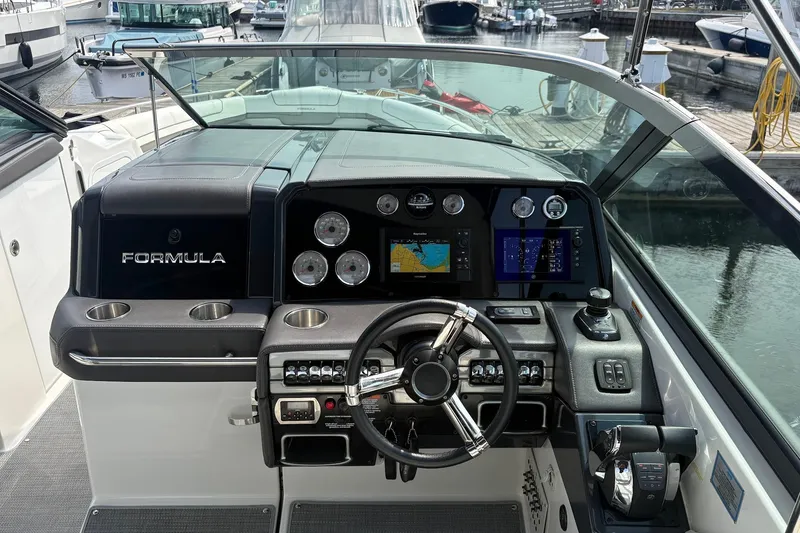 Slide: The Image of Cockpit of 2018 Formula 330 Crossover Bowrider I/O with modern controls and navigation displays. - 14