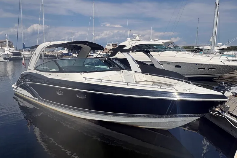 The Image of 2018 Formula 330 Crossover Bowrider I/O docked at marina, sleek design, sunny day. - 0