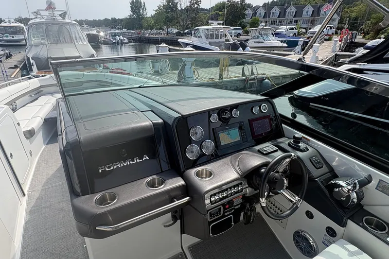 Slide: The Image of 2018 Formula 330 Crossover Bowrider I/O dashboard with modern controls and navigation system. - 13