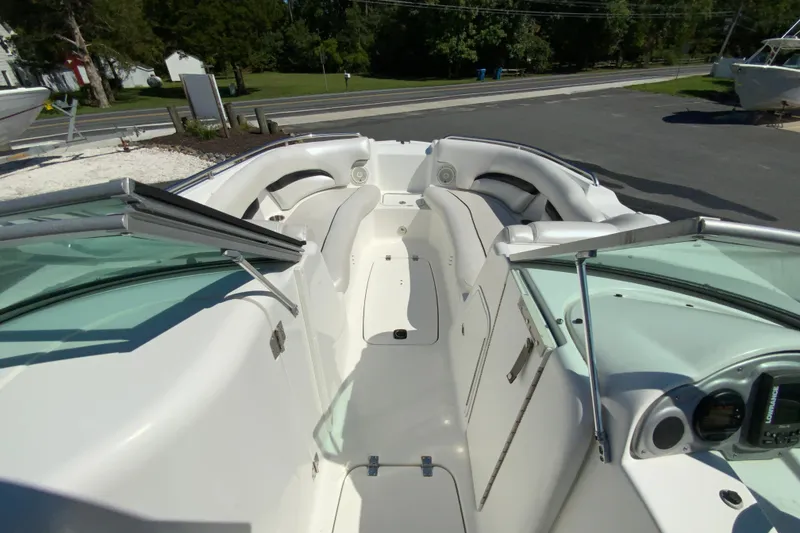 Slide: The Image of 2013 Hurricane SunDeck 2400 OB boat interior with seating and windshield. - 21