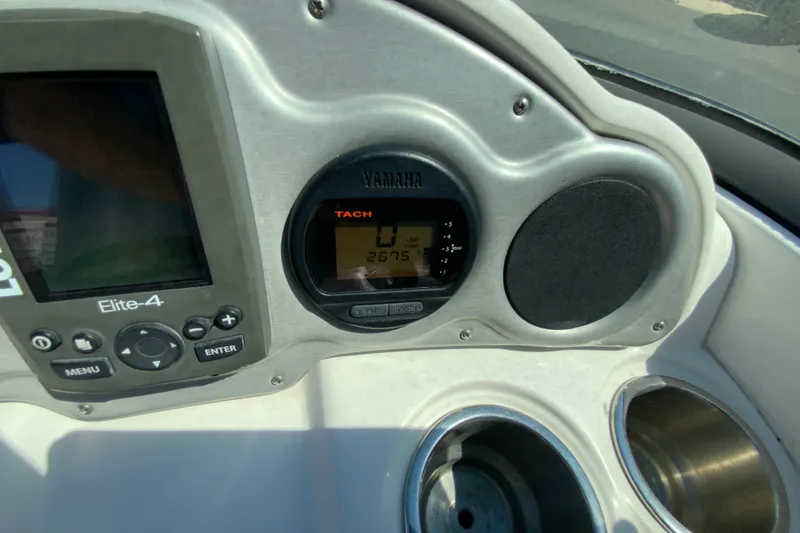 Slide: The Image of Dashboard of a 2013 Hurricane SunDeck 2400 OB boat with Yamaha tachometer and Elite-4 display. - 14