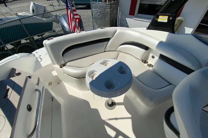 Slide: The Image of 2013 Hurricane SunDeck 2400 OB boat interior with seating and cup holders. - 19