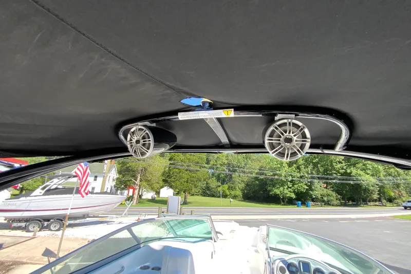 Slide: The Image of 2013 Hurricane SunDeck 2400 OB boat interior with speakers and canopy. - 30