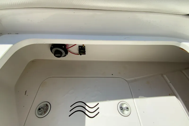 Slide: The Image of 2013 Hurricane SunDeck 2400 OB boat storage compartment with wiring and drainage. - 31