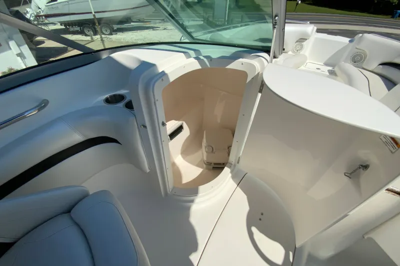Slide: The Image of 2013 Hurricane SunDeck 2400 OB boat interior with open storage compartment. - 20
