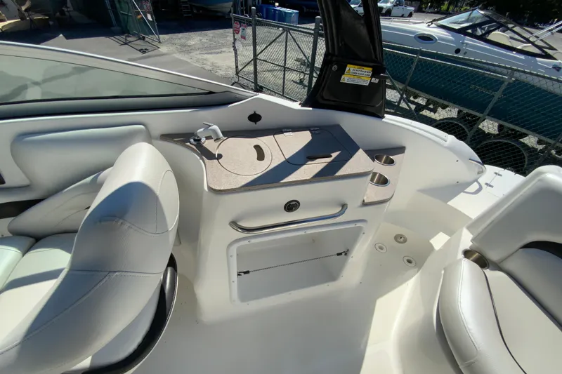 Slide: The Image of 2013 Hurricane SunDeck 2400 OB boat interior with seating and storage area. - 16