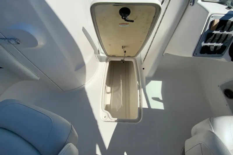 Slide: The Image of Open storage compartment on a 2013 Hurricane SunDeck 2400 OB boat interior. - 28