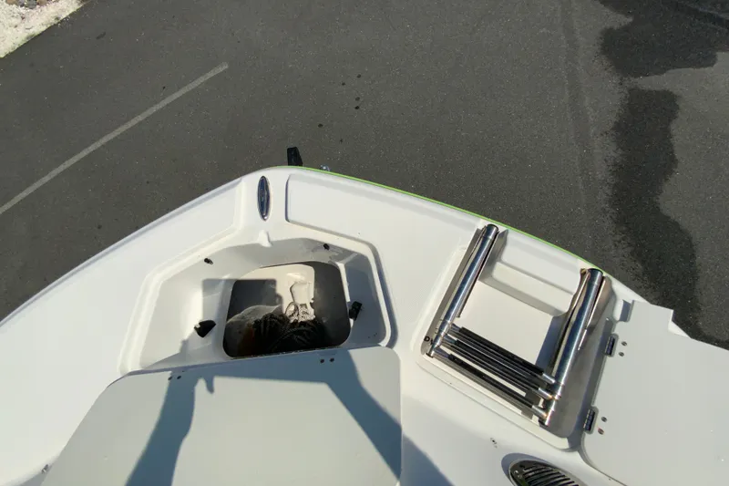 Slide: The Image of 2013 Hurricane SunDeck 2400 OB boat deck with ladder and storage compartment. - 24