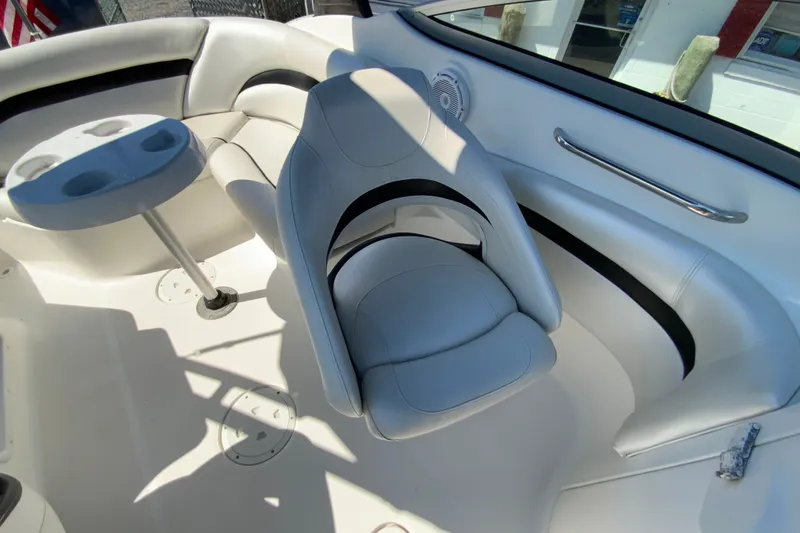 Slide: The Image of 2013 Hurricane SunDeck 2400 OB boat interior with seating and cup holders. - 32