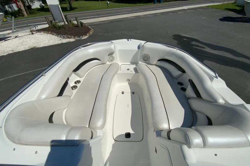 Slide: The Image of 2013 Hurricane SunDeck 2400 OB boat interior with white seating and cup holders. - 22