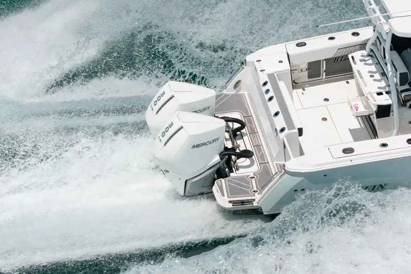 Slide: The Image of 2023 Blackfin 272 CC boat with dual Mercury outboard engines cruising on water. - 4