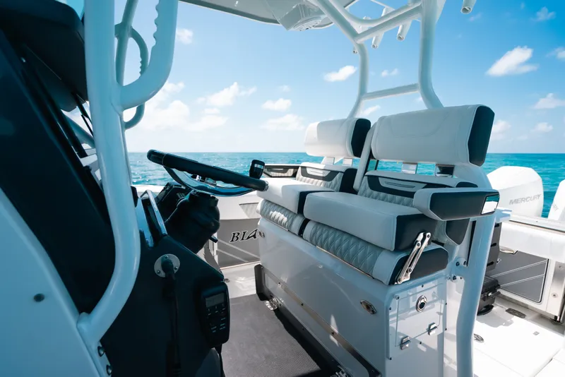 Slide: The Image of 2023 Blackfin 272 CC boat interior with luxurious seating and ocean view. - 17